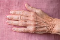 Old woman hand finger skin wrinkled. 