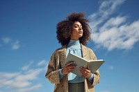 Reading a book female adult sky. 