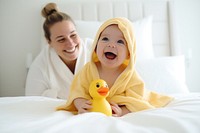 Baby wearing yellow hooded duck towel portrait blanket parent. 