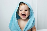 Baby laughing towel happy. 