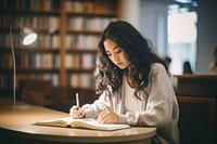 Writing sitting reading student. 