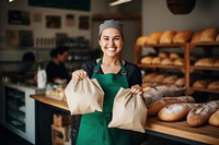 Bread smiling holding bakery. 