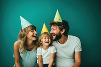 A family wearing party hat laughing portrait adult. 