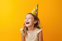 Girl wearing party hat laughing hairstyle yellow. 