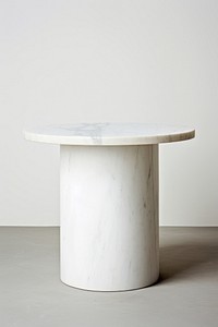 Elegant round marble table with a smooth surface. The marble table stands on a cylindrical base. Perfect for modern decor, this marble table adds sophistication.