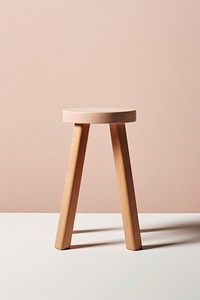 Minimalist wooden stool with three legs. Simple stool design. Wooden stool against a neutral background. Ideal for modern decor. Functional and stylish stool.