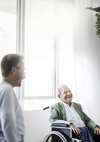 Senior man in wheelchair smiling. 