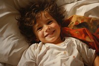 Smiling little child bed furniture portrait. 