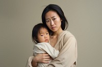 Stressed asian mother portrait hugging family. 