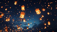 Floating lanterns in night sky. 