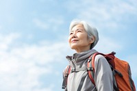 Senior woman hiking looking adult sky. 