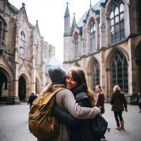 Diverse students study abroad architecture building hugging. 