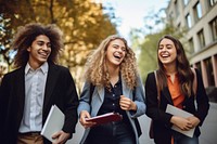 Students holding books laughing talking adult. 