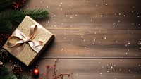 flatlay photo of christmas gift box ribbon ornaments pine branch mistletoe glitter minimal on wood table.  