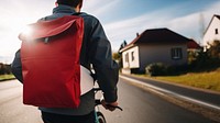 photo of a delivery rider wearing color jacket back view with white plain bag on a bike.  