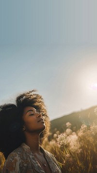 photo of happy black woman in a meadow.  