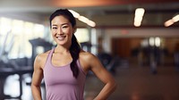 a photo of an Asian woman in sportswear standing in the gym. 