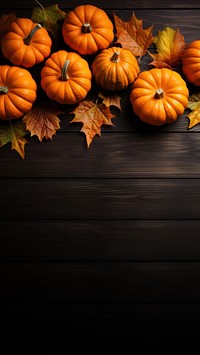 a top view photo of Pumpkins and maple leaves. 