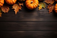 a top view photo of Pumpkins and maple leaves. 