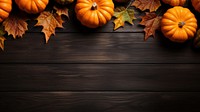 a top view photo of Pumpkins and maple leaves. 