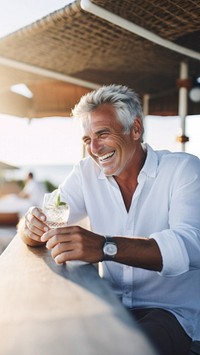 Close up photo of a middle-age men wearing white linen shirt. 