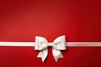 close up photo of a big white bow on gift box. 