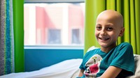 photo of a smiling young boy, cancer patient, in a hospital room. 