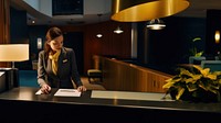Photo of female receptionist working at counter of hotel. AI generated Image by rawpixel.