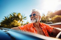 Photo of Happy senior man enjoying summer road trip, luxury cabriolet adventure.