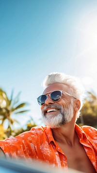 Photo of Happy senior man enjoying summer road trip, luxury cabriolet adventure.