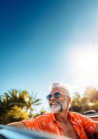 Photo of Happy senior man enjoying summer road trip, luxury cabriolet adventure.