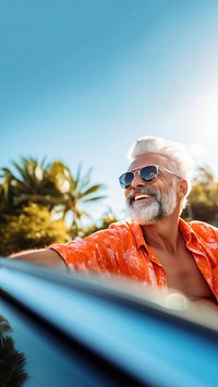 Photo of Happy senior man enjoying summer road trip, luxury cabriolet adventure.