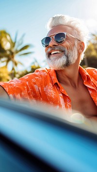 Photo of Happy senior man enjoying summer road trip, luxury cabriolet adventure.