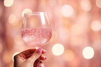 Woman holding pink cocktail, pink bokeh. .