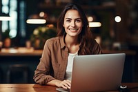 Nice american woman using laptop computer sitting typing. 