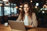 Nice american woman using laptop computer sitting typing. 