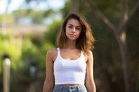 Pretty woman wearing white tanktop portrait outdoors photo. 