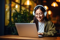 Asian girl working laptop headphones computer. 