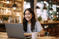 Asian girl working laptop computer coffee. 