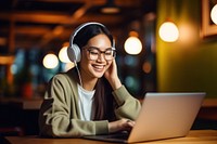 Asian girl working laptop headphones computer. 