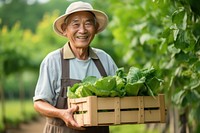 Happy old asian gardening vegetable holding. 