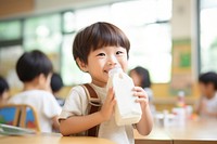 Kid drinking milk carton classroom child refreshment. 