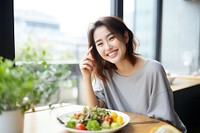 Female eating healthy vegan food table smile adult. AI generated Image by rawpixel.