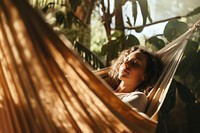 Woman napping on hammock. 