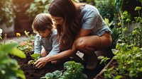 A photo of mother teaching her child how to dig in the backyard garden.  