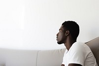 Depressed adult sitting sofa contemplation. AI generated Image by rawpixel.