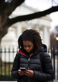 african_american_teen_using_phone_near_Whitehouse.jpg --style raw