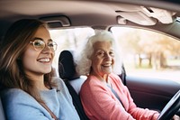 Woman driving car with grandmother. 