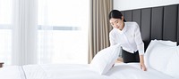 Hotel staff making bed. AI generated Image by rawpixel.