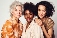 Three women smiling together. Diverse group of women. Friendship among women. Happy women in casual attire. Women supporting women.